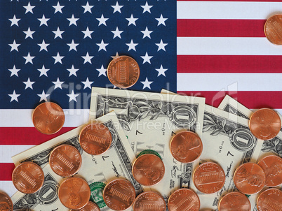 Dollar notes and coins and flag of the United States