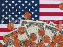 Dollar notes and coins and flag of the United States