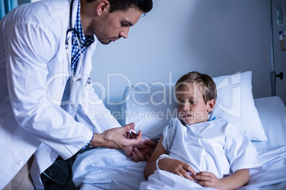 Male doctor injecting patient