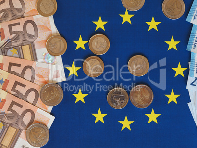 Euro notes and coins, European Union, over flag