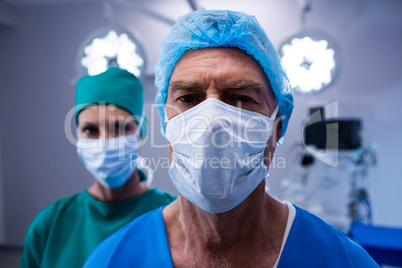Portrait of surgeons wearing surgical mask in operation theater