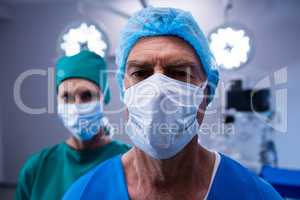 Portrait of surgeons wearing surgical mask in operation theater