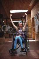 Disabled schoolgirl on wheelchair in corridor at school