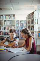 Classmates doing homework in library