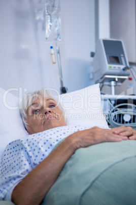 Worried senior patient lying on bed
