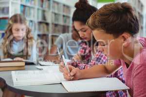 Attentive classmates studying in library