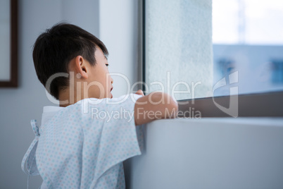 Boy patient looking out from the window