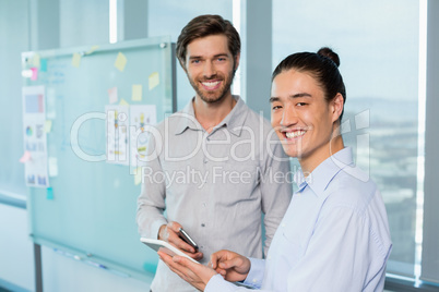 Business executives discussing over digital tablet at office