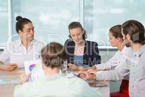 Business executives discussing with each other in conference room