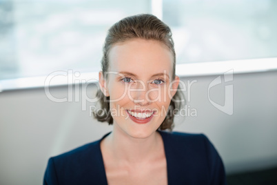 Smiling female business executive sitting in office