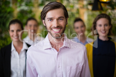 Business executives smiling while standing in office