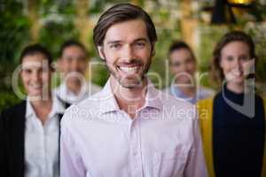 Business executives smiling while standing in office