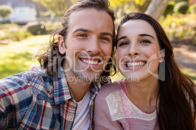 Young couple smiling in park