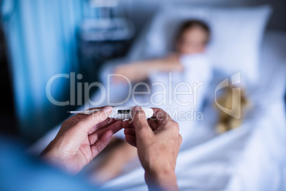Female doctor holding thermometer at hospital