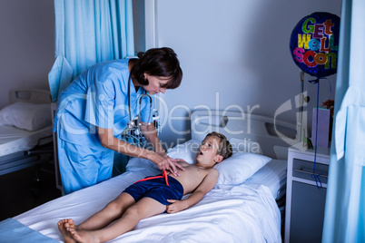 Female doctor examining abdomen of patient