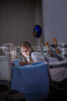 Patient using digital tablet in ward at hospital