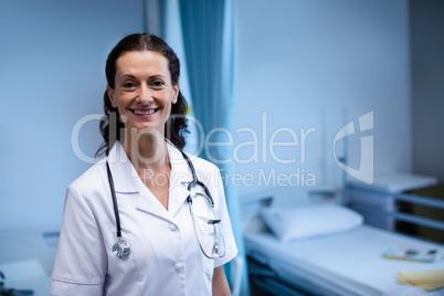 Portrait of female doctor standing in ward