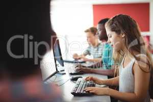 Students using computer in classroom