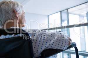 Disabled senior patient on wheelchair in hospital passageway at hospital