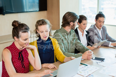 Business team interacting with each other in conference room