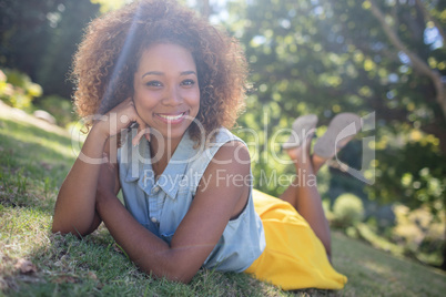 Smiling woman lying on a grass