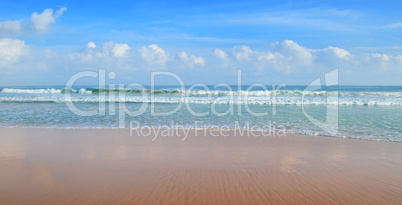 ocean, sandy beach and blue sky