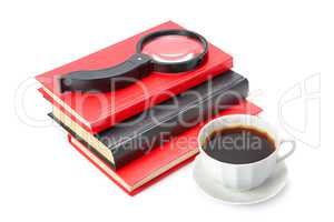 Books, a cup of coffee and magnifier isolated on white backgroun
