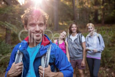 Portrait of young man hiking with his friends