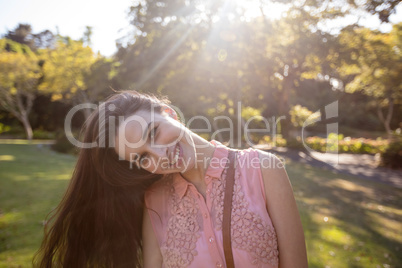 Portrait of beautiful woman swaying her hair in the park