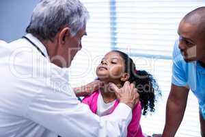 Doctor examining patients neck