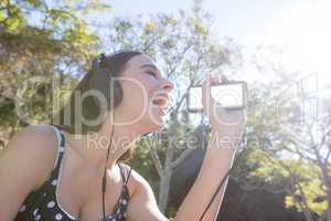 Happy woman listening to music on mobile phone