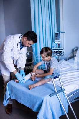 Male doctor examining patient leg