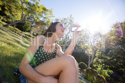 Happy woman listening to music on mobile phone