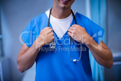 Close-up of male doctor standing with stethoscope in ward