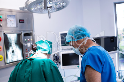 Male and female surgeon working in operation theater