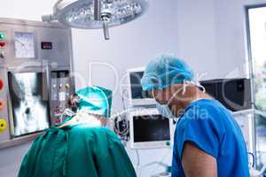 Male and female surgeon working in operation theater