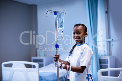 Patient holding IV stand at hospital