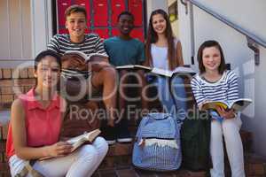 Portrait of students sitting on staircase