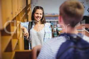 Happy students interacting with each other in locker room