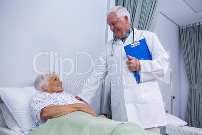 Doctor consoling senior patient