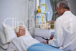 Doctor discussing medical report with senior patient