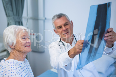 Doctor discussing x-ray report with senior patient