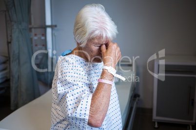 Senior patient standing at hospital