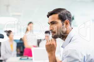 Thoughtful business executive sitting at desk