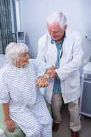 Doctor assisting senior patient at hospital