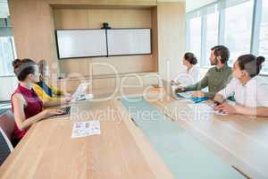 Business team looking at white screen in the meeting room