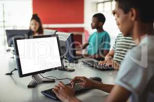 Students using computer in classroom