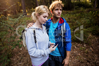 Hiking couple checking the compass