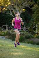 Female jogger listening to music while jogging