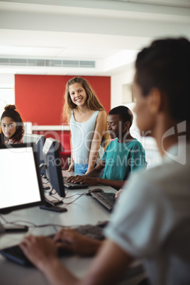 Students using computer in classroom